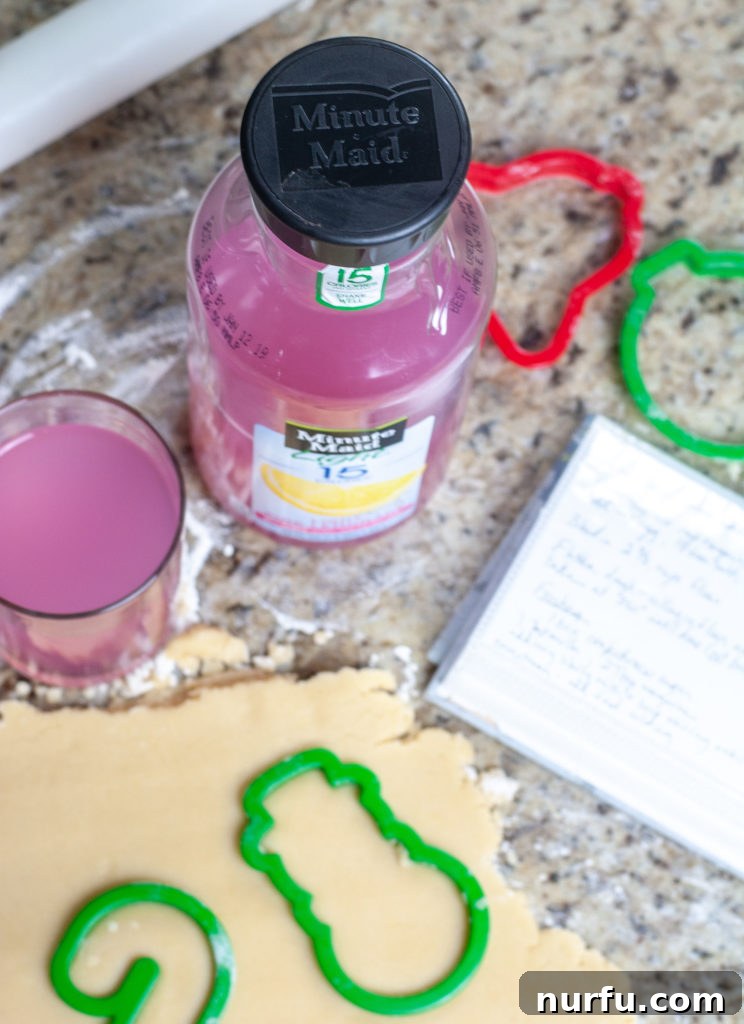 Crafting Unforgettable Holiday Moments with Kids 5 A bottle of Minute Maid Pink Lemonade next to freshly baked cookie dough and sprinkles.