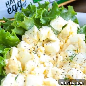 Perfectly Creamy Homemade Egg Salad 4 Egg salad served in a lettuce cup, garnished with fresh herbs.