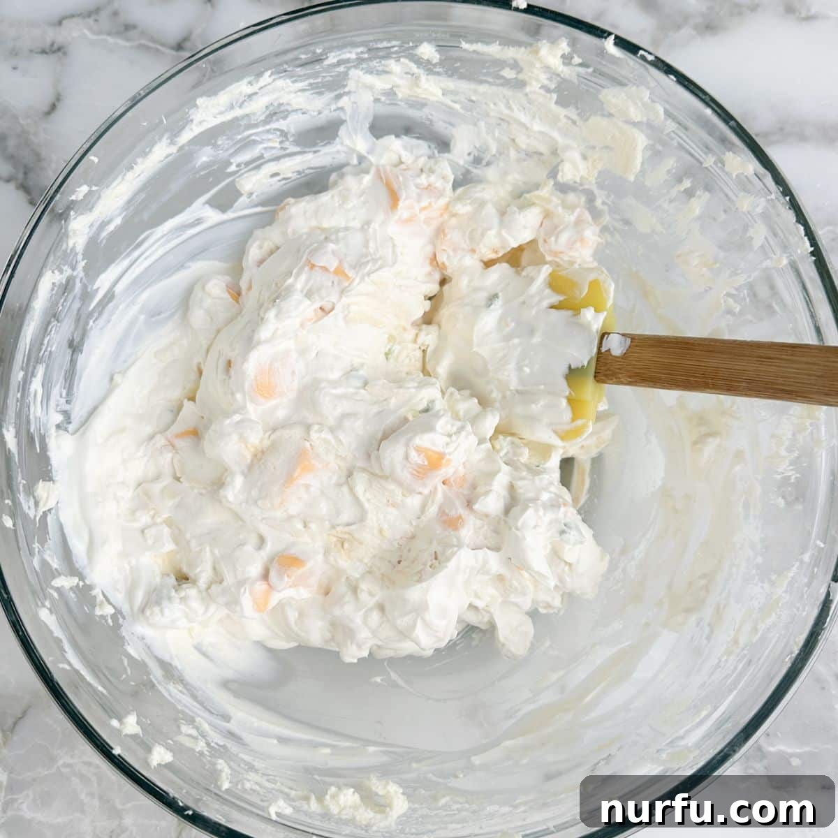 Whisker Rage Plunge 5 A bowl showing a smooth mixture of sour cream and cream cheese, forming a rich, creamy base for the dip.