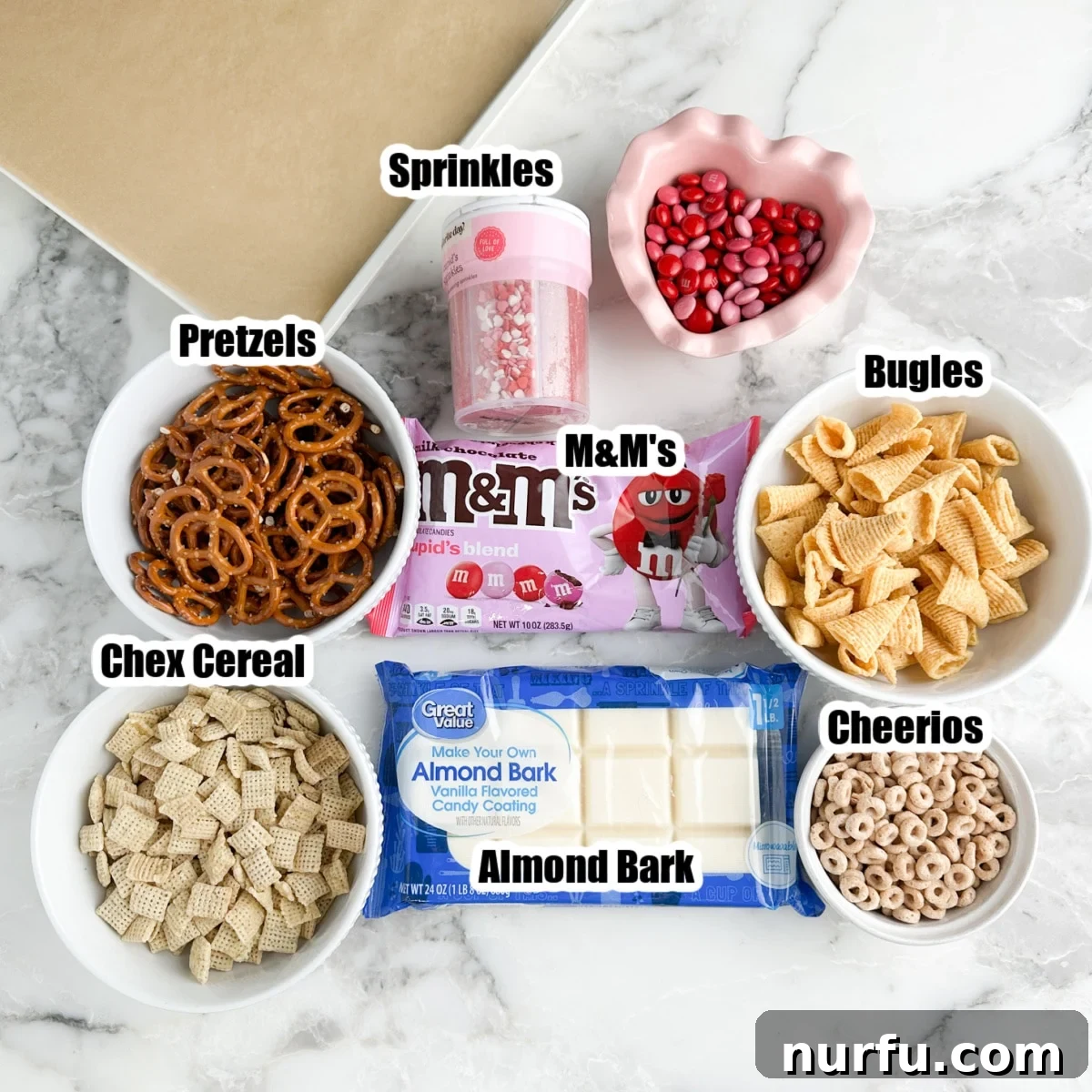 Bag of M&M's, sprinkles, pretzels, Bugles, Chex, almond bark, and Cheerios.