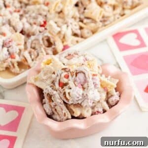 Pink bowl with cupid crunch snack mix.