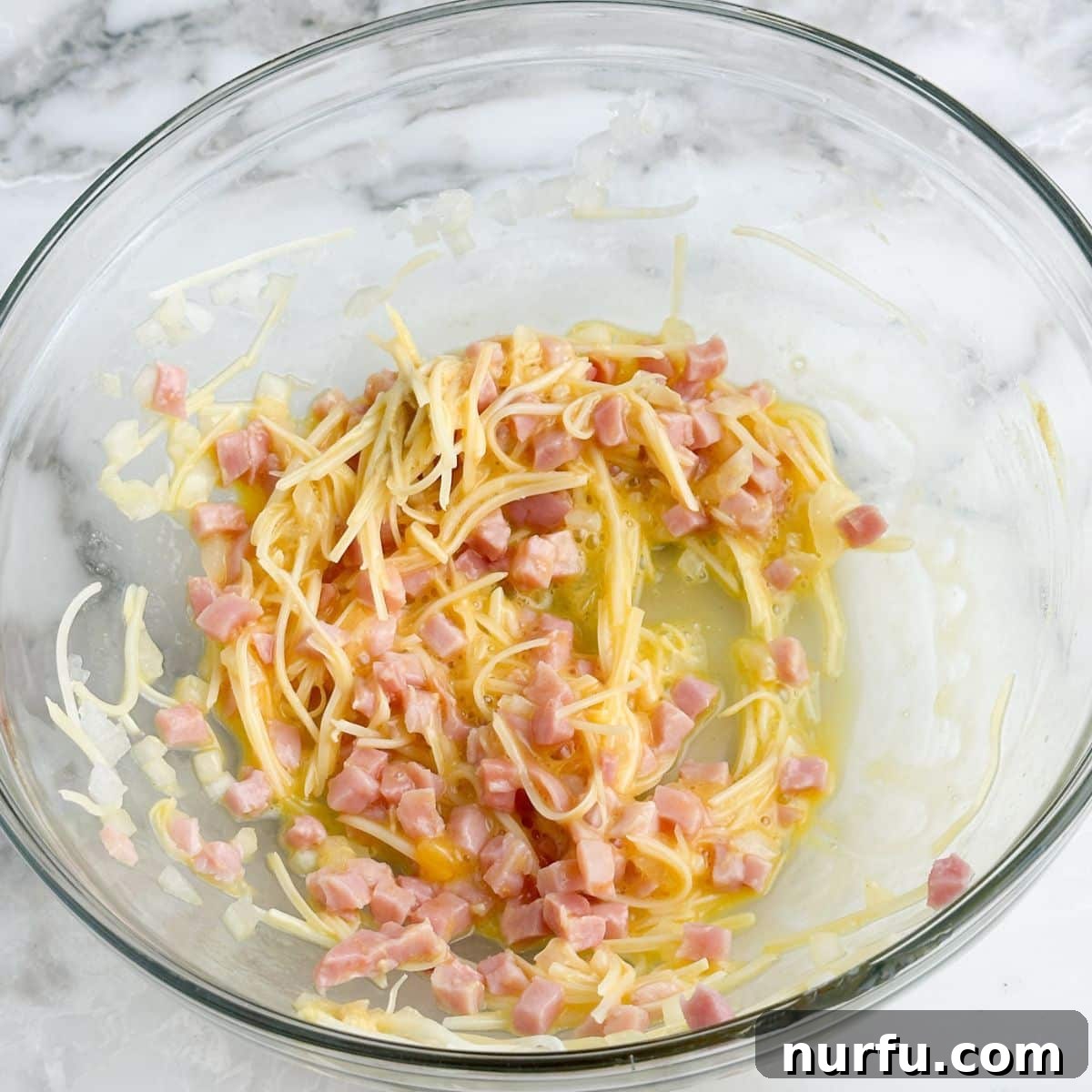 Savory Ham Puffs 6 A mixing bowl filled with the savory ham, Swiss cheese, onion, egg, and Dijon mustard filling.