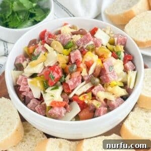 New Orleans Muffuletta Party Dip 7 Bowl of muffuletta dip surrounded by toast.