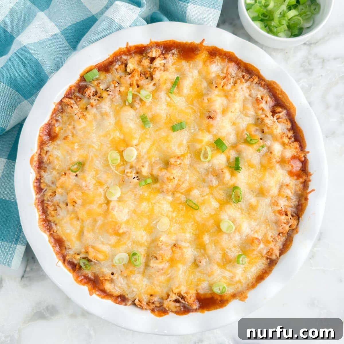 Fiesta Chicken Tamale Bake 9 The fully baked chicken tamale pie in a baking dish, with the cheese melted and bubbly.