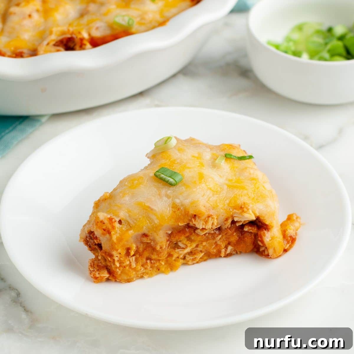 Fiesta Chicken Tamale Bake 10 A perfectly portioned slice of chicken tamale pie on a white plate, ready to be enjoyed.