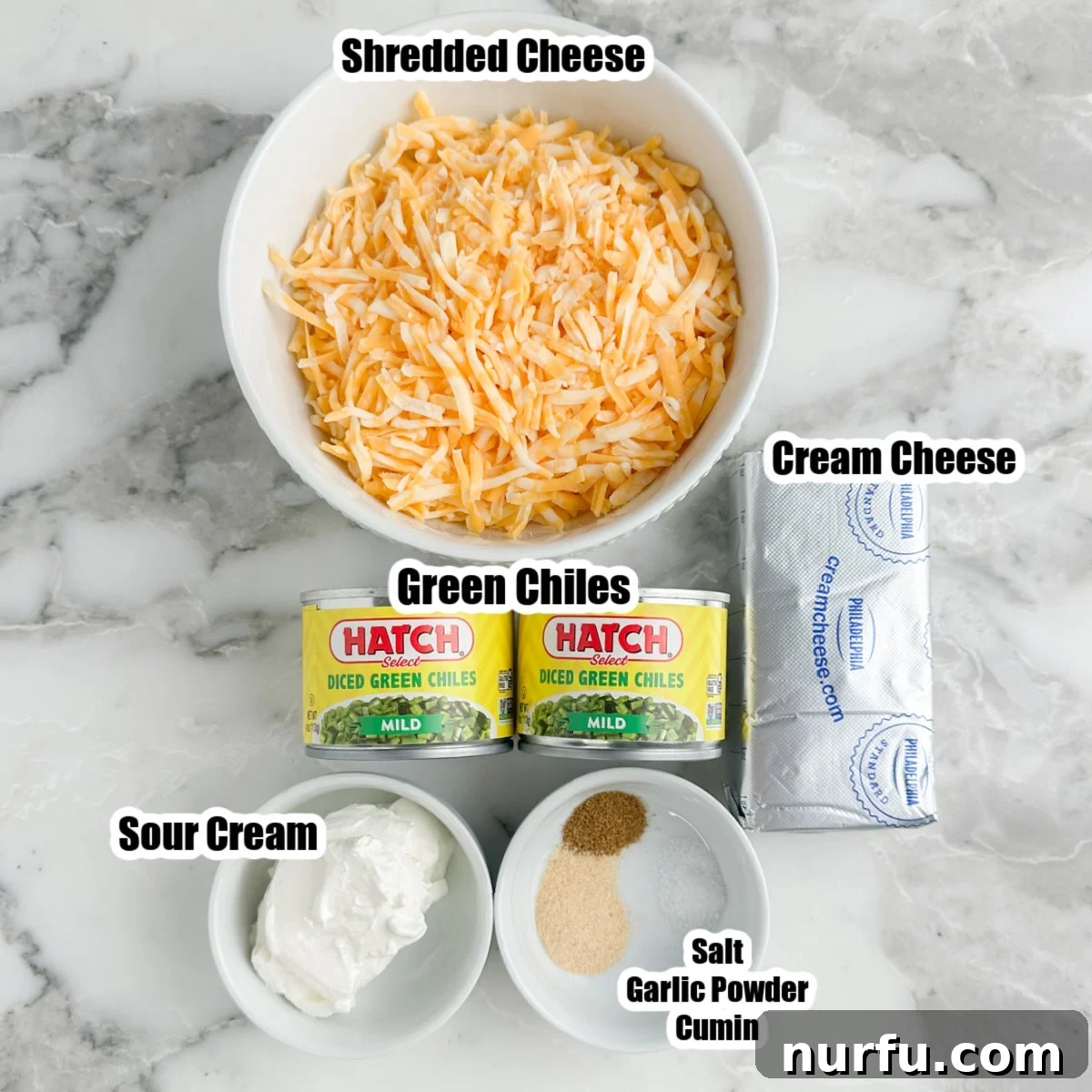 Zesty Green Chile Dip 3 Bowl of shredded cheese, sour cream, cream cheese, cans of green chiles, bowl of salt, garlic powder, and cumin.