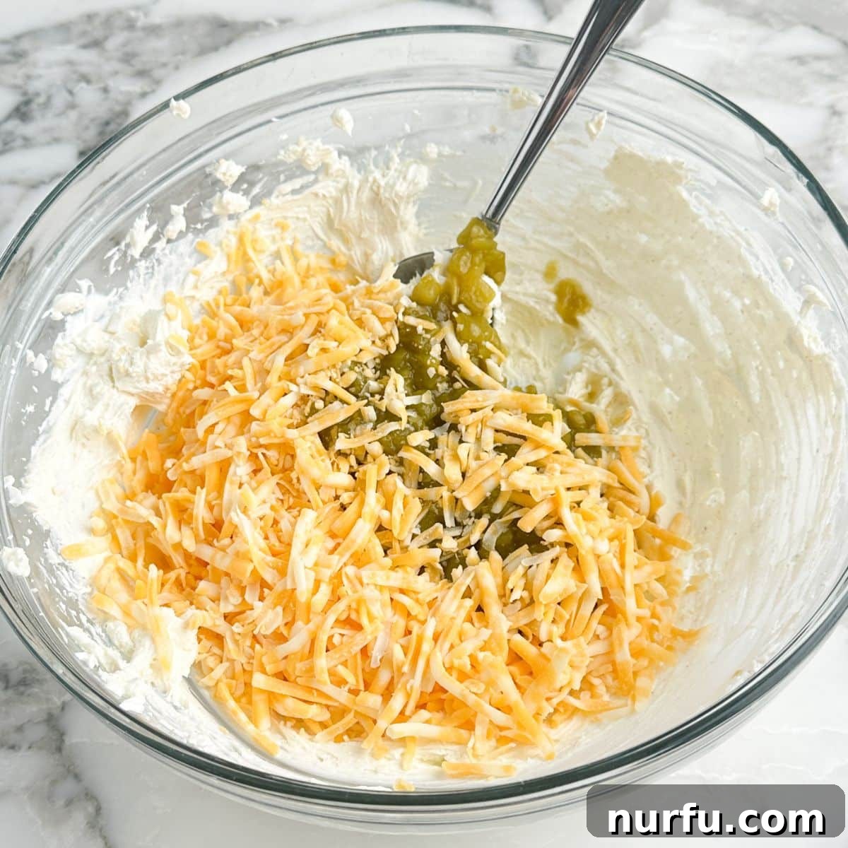 Zesty Green Chile Dip 5 Bowl of whipped cream cheese, shredded cheese, and green chiles.