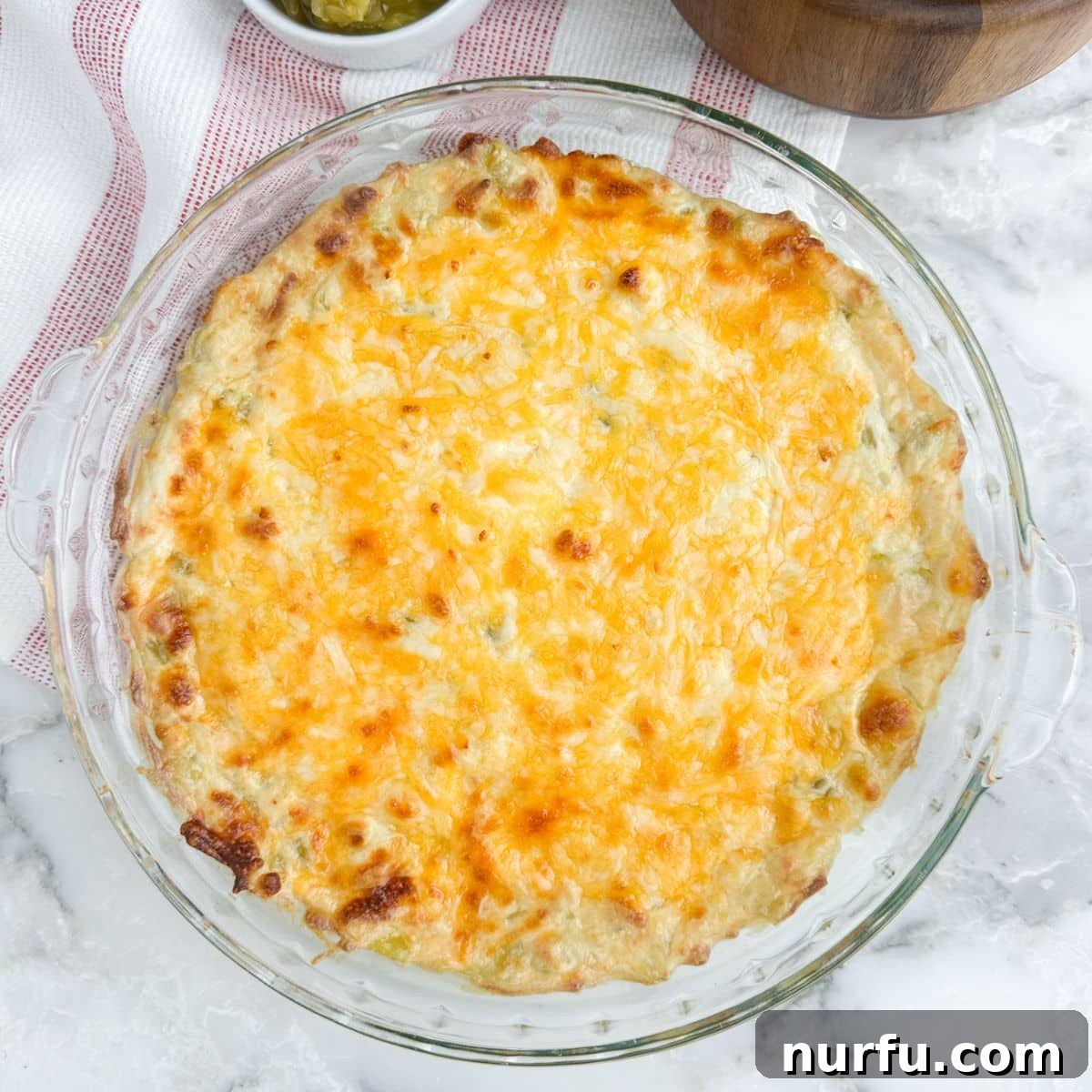 Zesty Green Chile Dip 7 Pie dish with baked green chili dip.