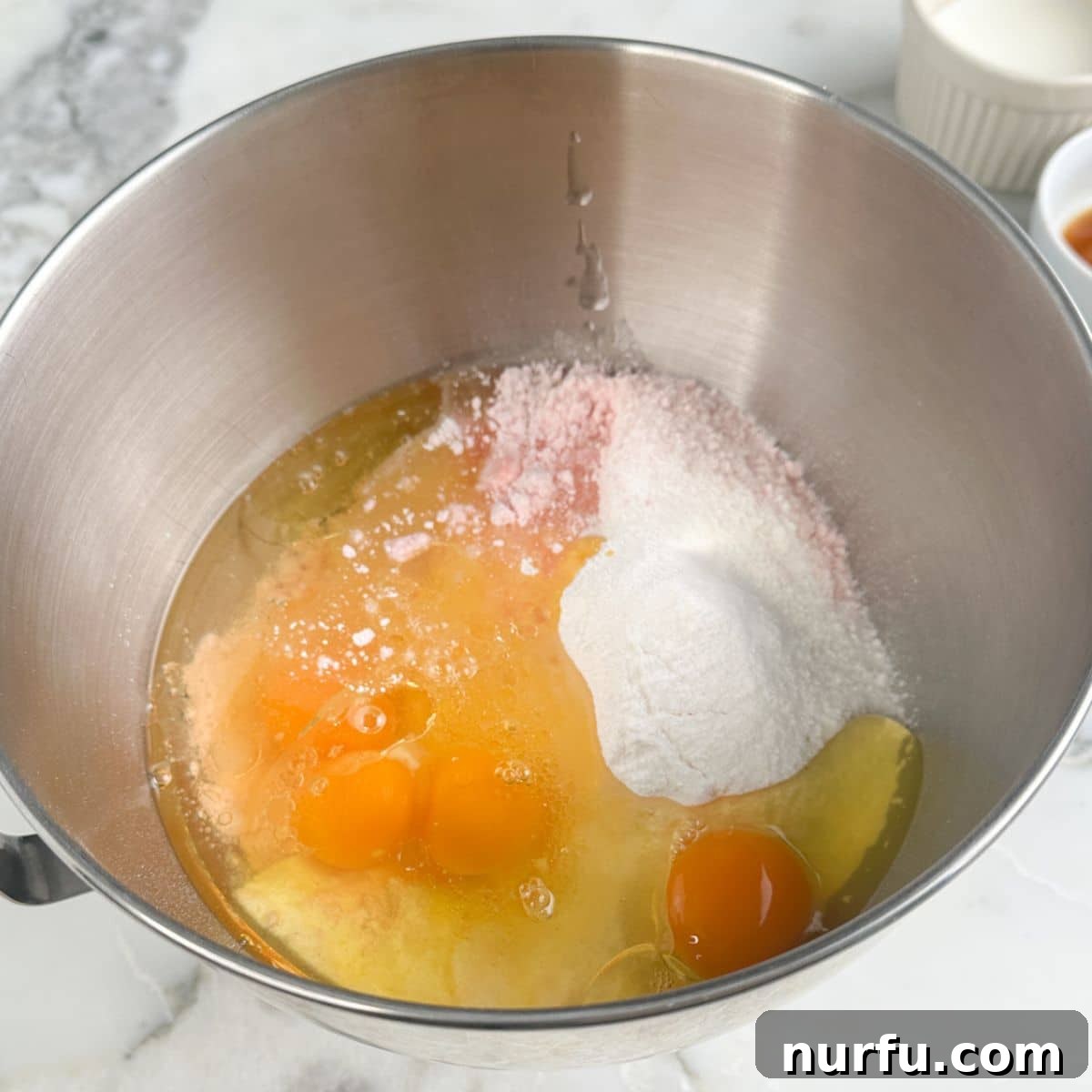 Strawberry Bloom Delights 4 Pink cake batter in a mixing bowl.