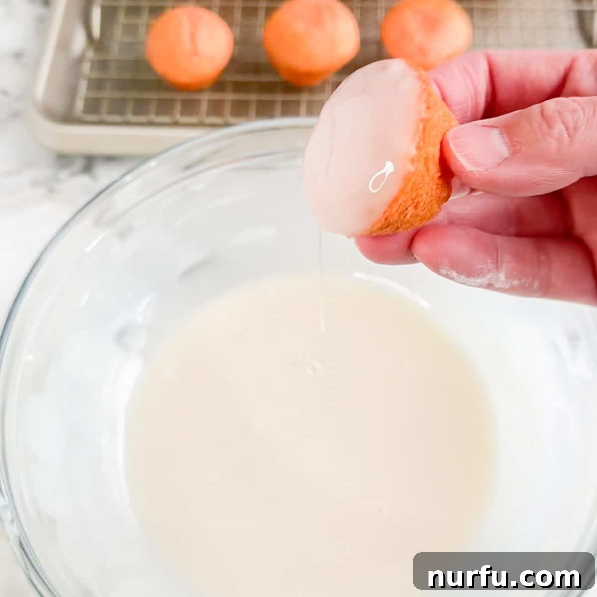 Strawberry Bloom Delights 6 Bowl of icing with a mini strawberry cake dipping in the icing.