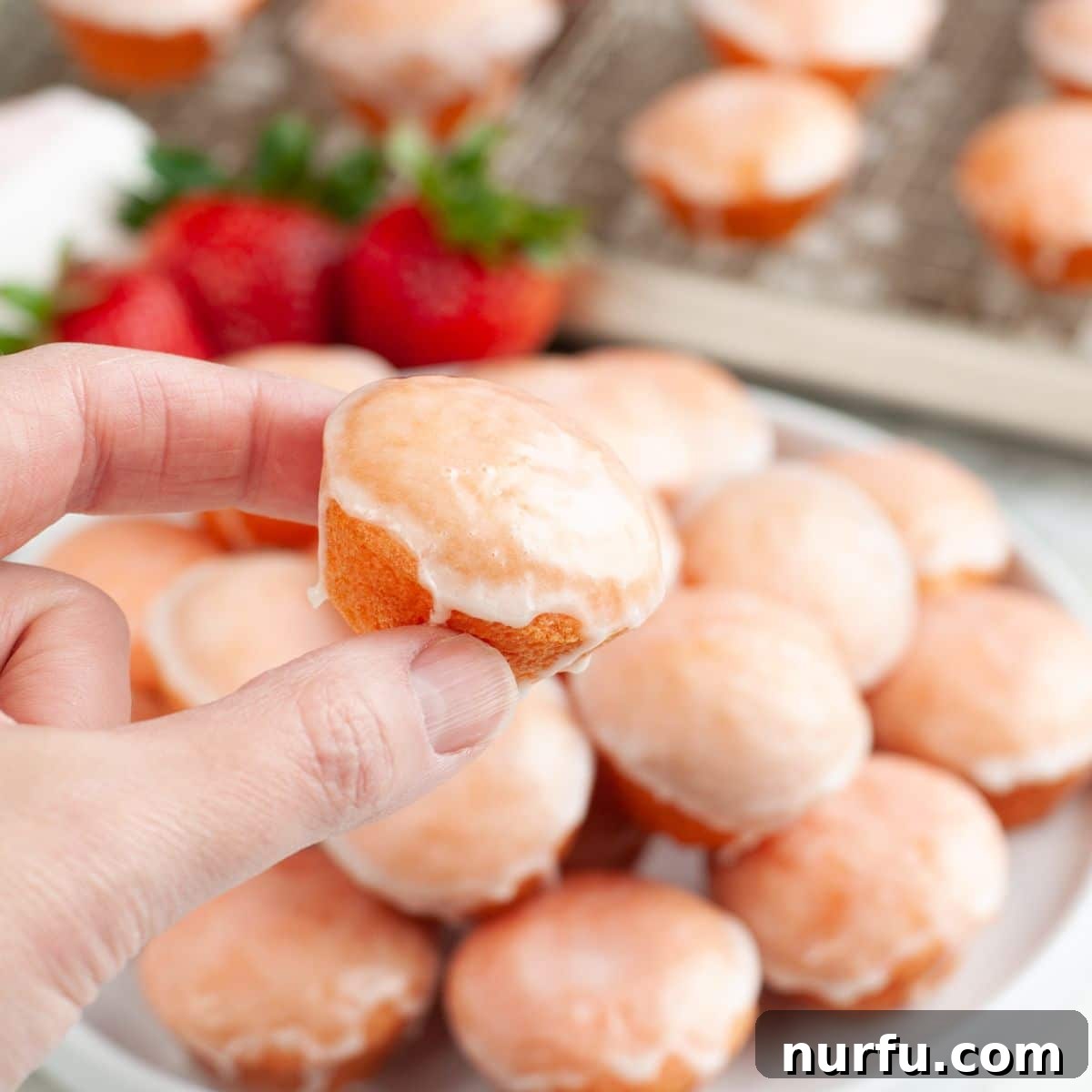 Strawberry Bloom Delights 7 Hand holding a mini strawberry cake.