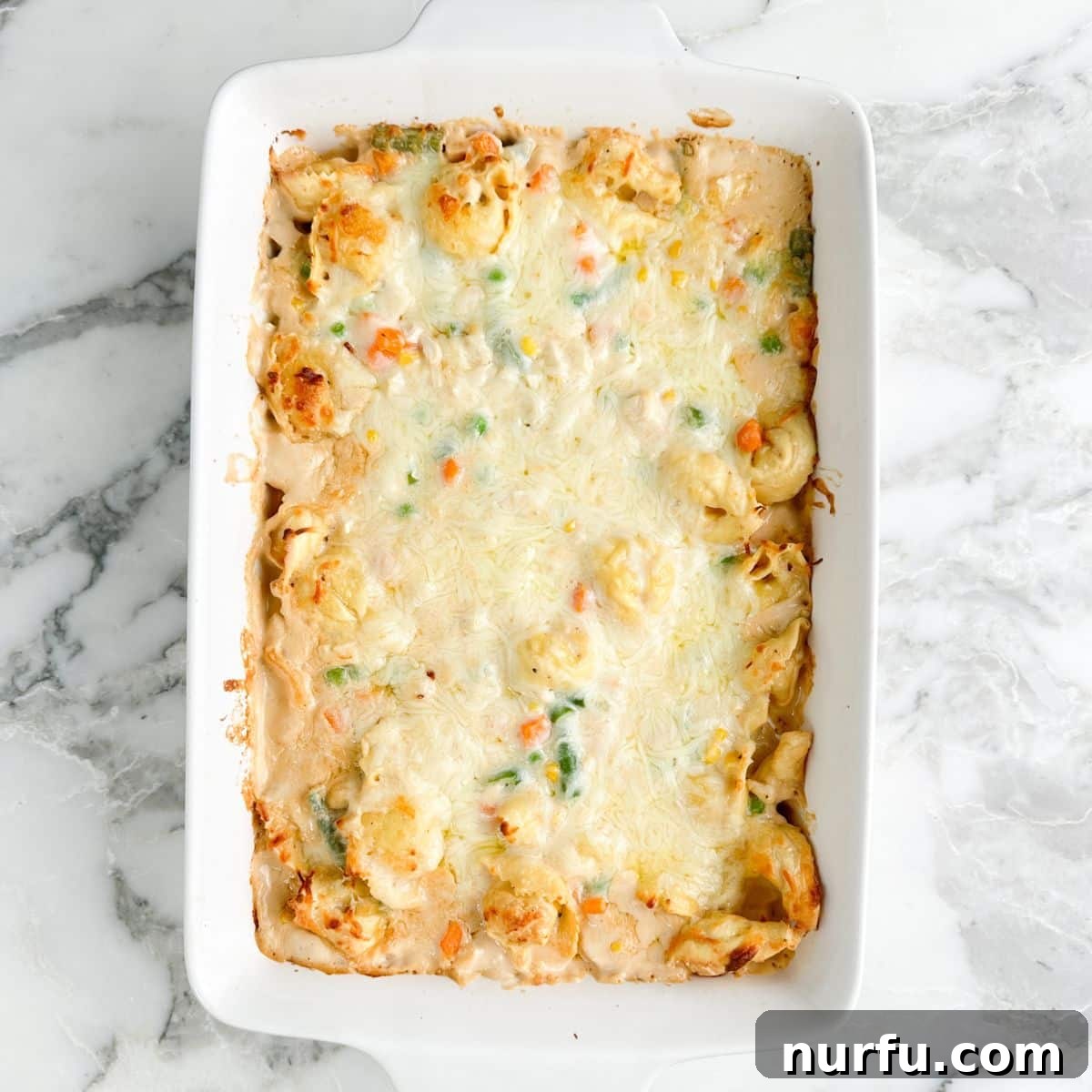 Casserole dish with chicken tortellini casserole. 