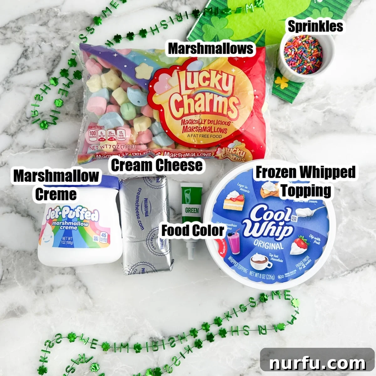 Pot of Gold Dessert Dip 3 Bag of colorful marshmallows, jar of marshmallow creme, cream cheese, green food coloring, and Cool Whip, ready for the St. Patrick's Day dessert dip.