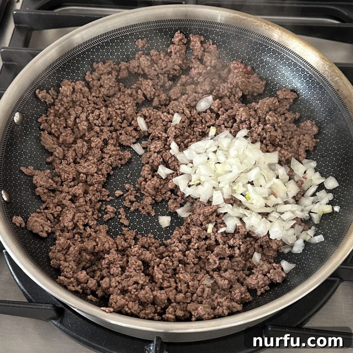 Mississippi Roadhouse Sloppy Joes 4 Skillet with browned ground beef and diced onions ready for seasonings.