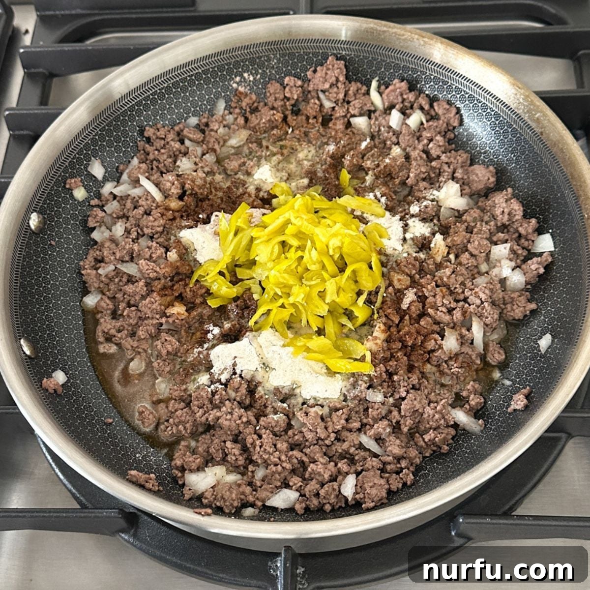 Mississippi Roadhouse Sloppy Joes 6 Skillet with ground beef, pepperoncinis, and seasonings simmering.