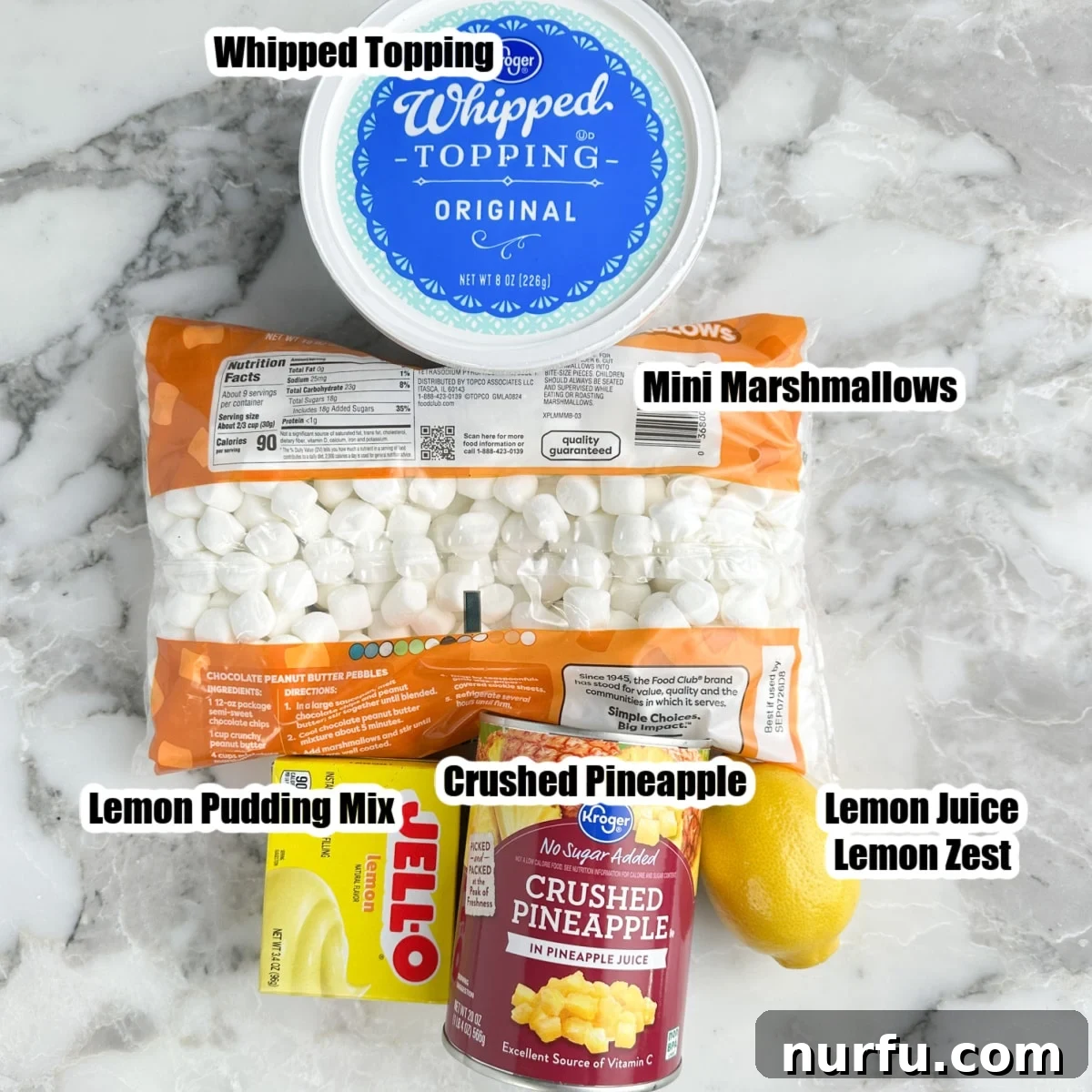 The essential ingredients for Lemon Fluff: whipped topping, mini marshmallows, instant lemon pudding mix, and a can of crushed pineapple.