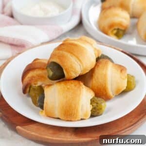 Tangy Pickle Bites 10 Plate of pickles in a blanket.