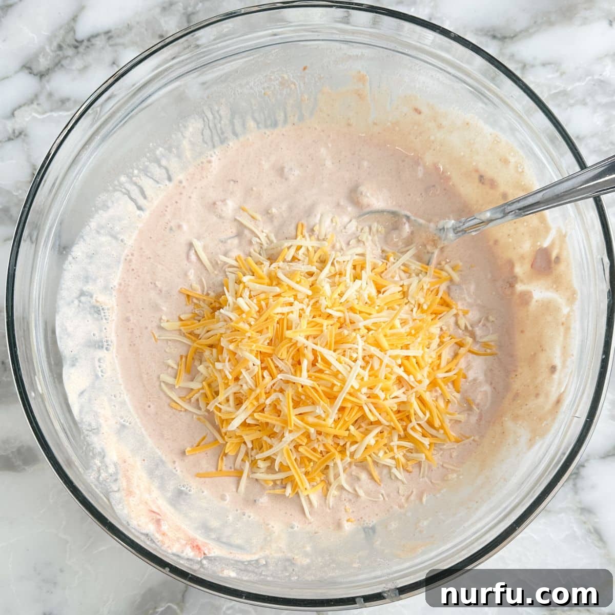 Zesty Fiesta Ranch Dip 7 The fiesta dip after shredded cheese has been added, ready for final mixing.
