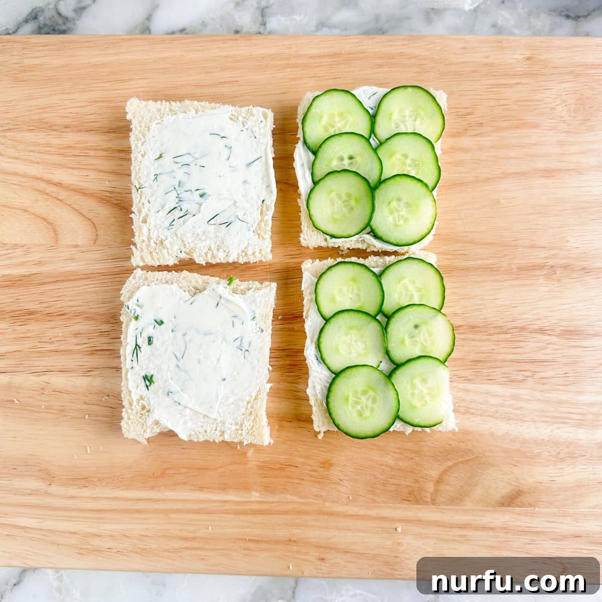 Elegant Cucumber Tea Bites 7 Pieces of bread spread with cream cheese and layered with sliced cucumbers, before topping.
