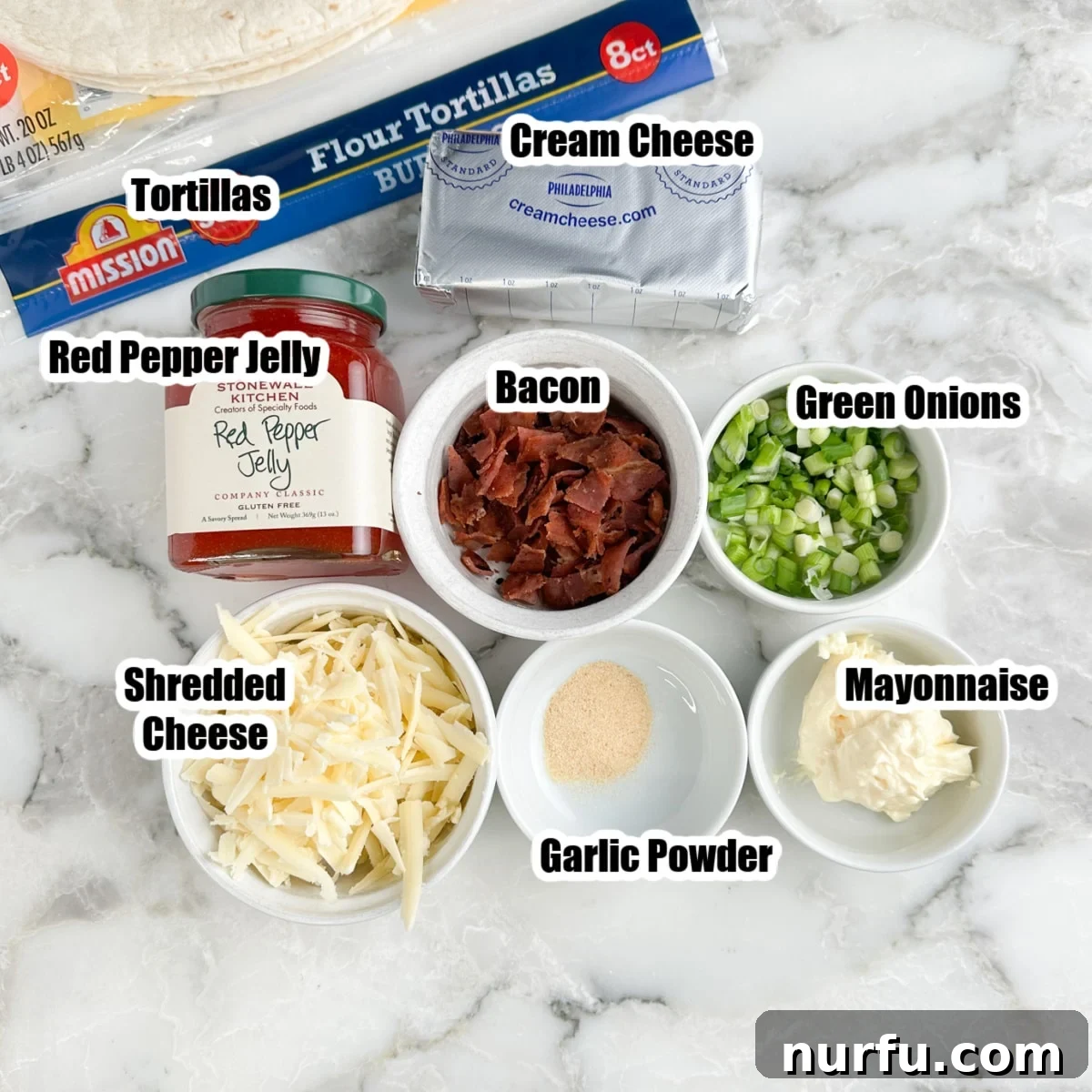 Sweet Heat Pinwheels 3 A vibrant flat lay of all the essential ingredients for pepper jelly pinwheels: a jar of pepper jelly, soft flour tortillas, crumbled bacon, shredded cheddar cheese, cream cheese, mayonnaise, garlic powder, and freshly chopped green onions.