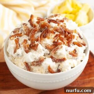 Bowl of pineapple pretzel fluff, a sweet and salty dessert delight.