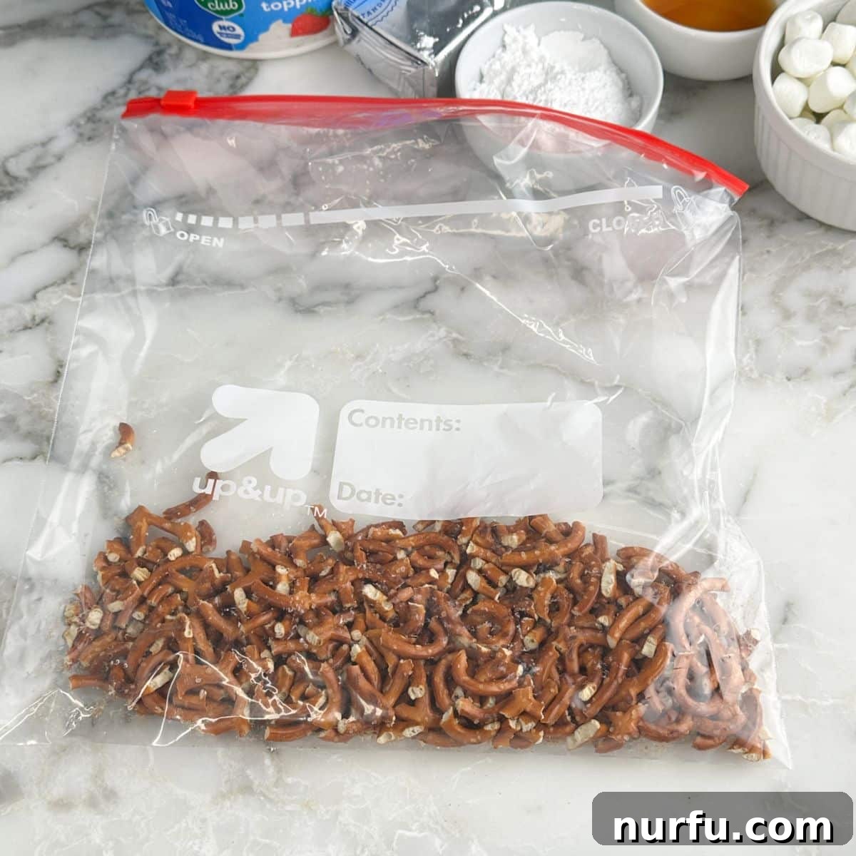 Sweet and Salty Pineapple Swirl 4 Bag of broken pretzels, ready to be mixed for the crust.