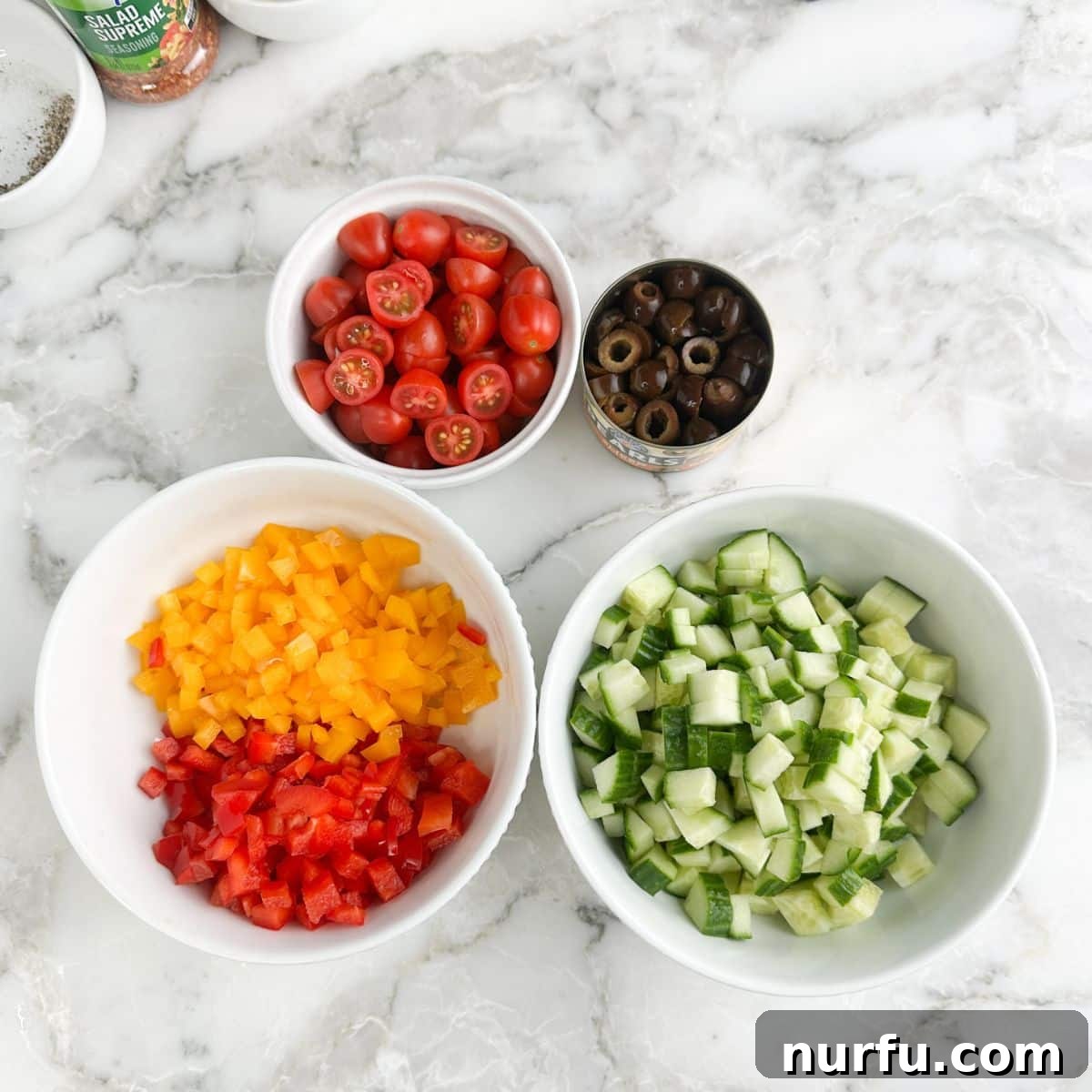 Zesty Spaghetti Salad 5 Bowl of diced cucumber, diced bell peppers, tomatoes, and sliced olives.