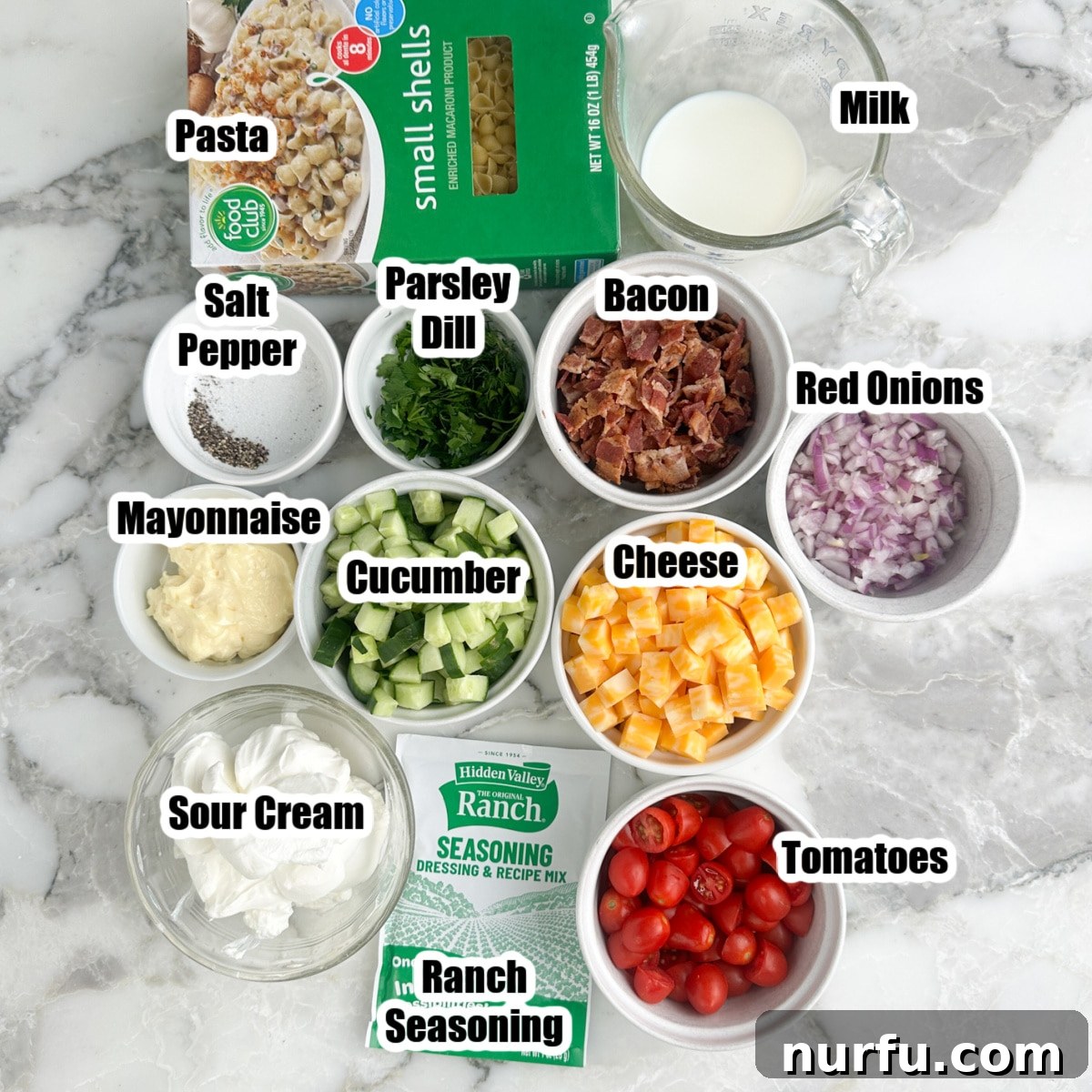 Creamy Ranch Pasta Salad Recipe with Bacon and Veggies 3 Ingredients for ranch pasta salad: pasta, mayo, sour cream, milk, bacon, onions, cucumbers, cheese, herbs, and ranch seasoning.