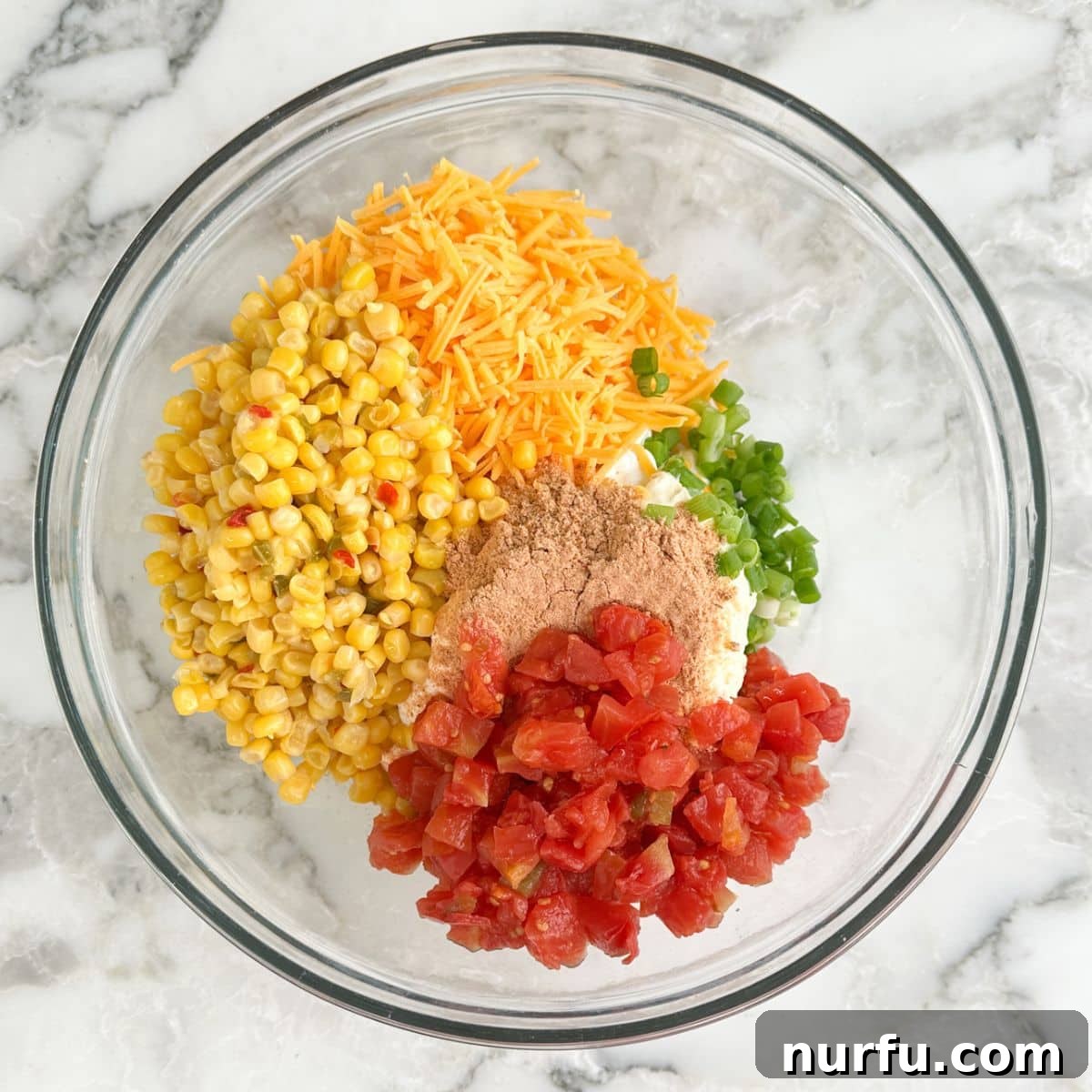 Creamy Fiesta Corn Dip Recipe for Parties and Game Day 4 Bowl with corn kernels, diced tomatoes, shredded cheese, seasonings, green onion, and sour cream.