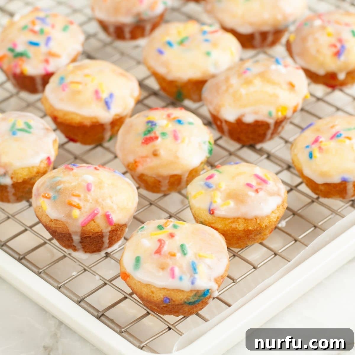 How to Make Sprinkle Blossoms: Cute Cake & Cookie Toppers 7 Cooling rack with mini sprinkle cakes.