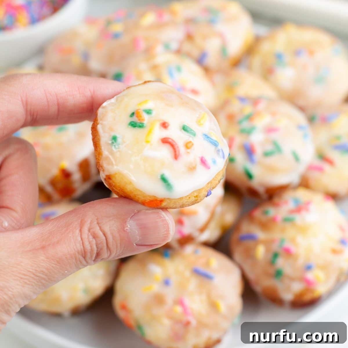 How to Make Sprinkle Blossoms: Cute Cake & Cookie Toppers 8 Hand holding a sprinkle blossom cake.