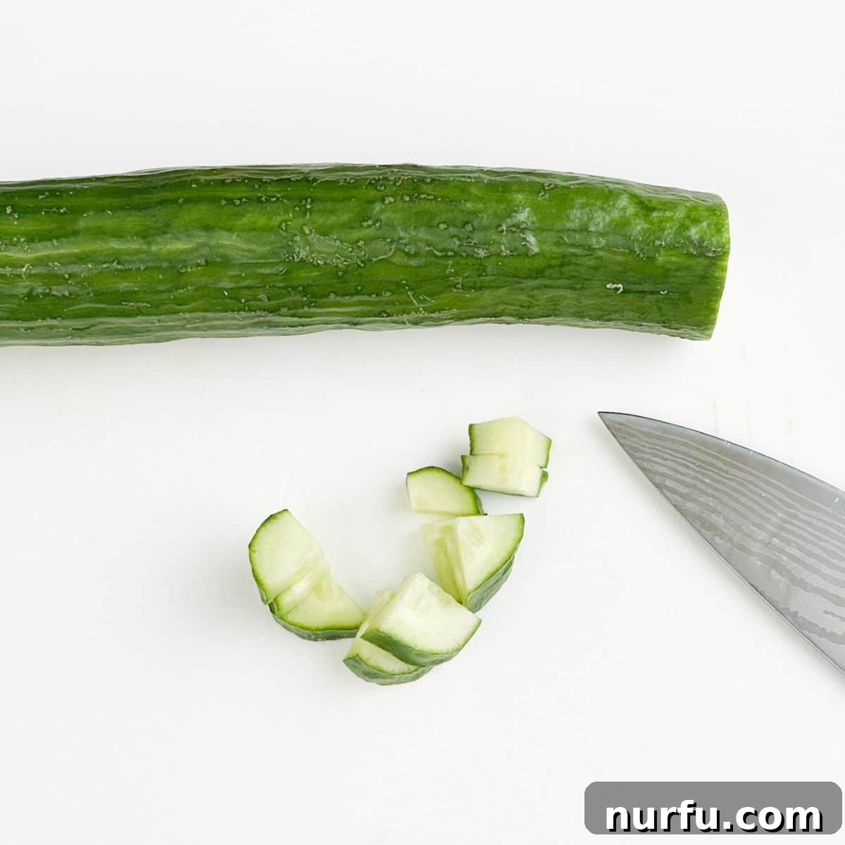 Strawberry Cucumber Salad with Mint and Balsamic Dressing 4 Diced cucumber with a knife.