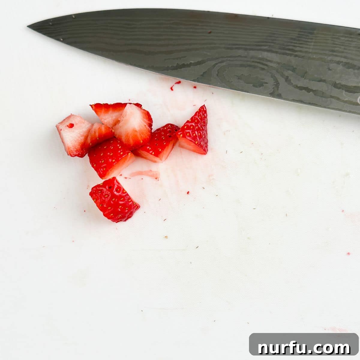 Strawberry Cucumber Salad with Mint and Balsamic Dressing 5 Diced strawberries with a knife.