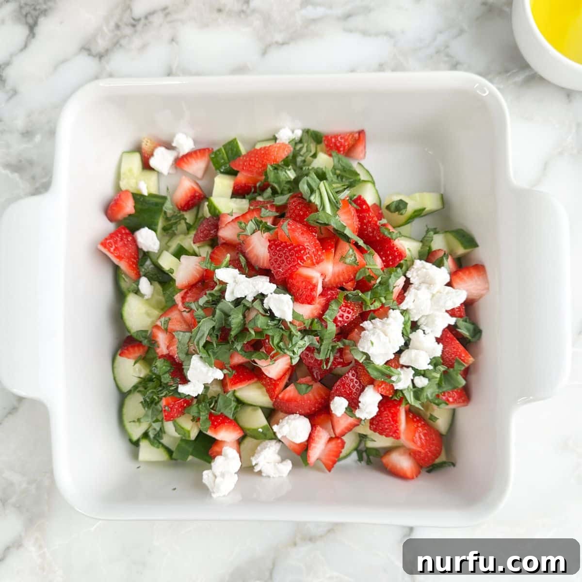 Strawberry Cucumber Salad with Mint and Balsamic Dressing 7 Dish with strawberry cucumber salad.