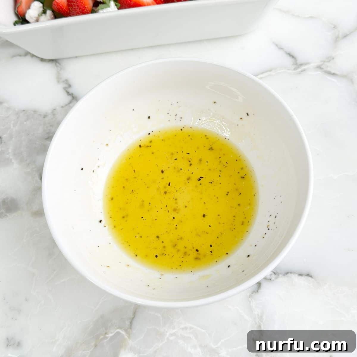 Strawberry Cucumber Salad with Mint and Balsamic Dressing 8 Bowl with vinaigrette.