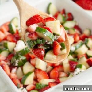Strawberry Cucumber Salad with Mint and Balsamic Dressing 10 Spoon with strawberry cucumber salad.
