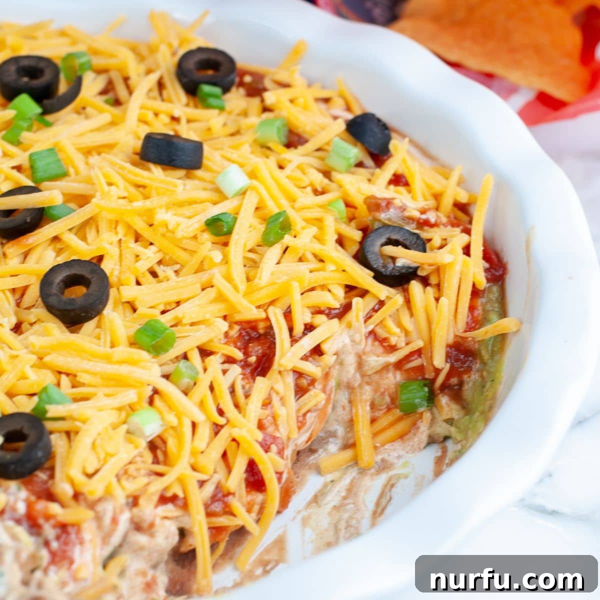 Creamy 5-Layer Dip Recipe for Parties and Game Day 7 Pie dish with 5 layer dip.