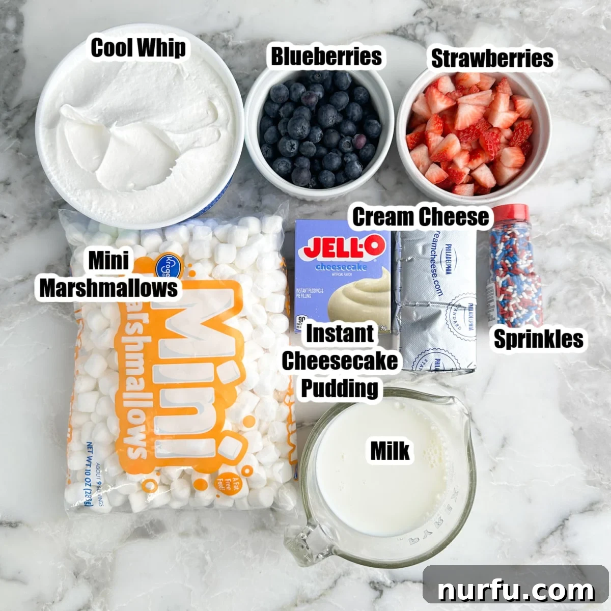 Patriotic Red, White & Blue Cheesecake Salad Recipe 3 Bowl of Cool Whip, mini marshmallows, instant pudding mix, milk, cream cheese, and bowls of blueberries, and strawberries.