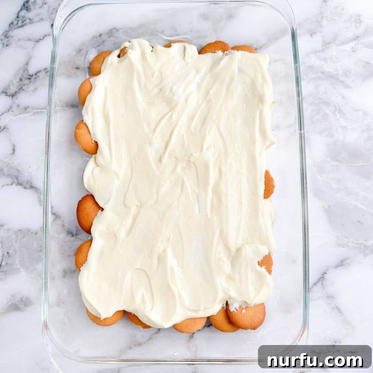 Strawberry Pudding Dessert Recipe: Creamy Berry Delight 5 Nilla wafers topped with pudding in a baking dish.