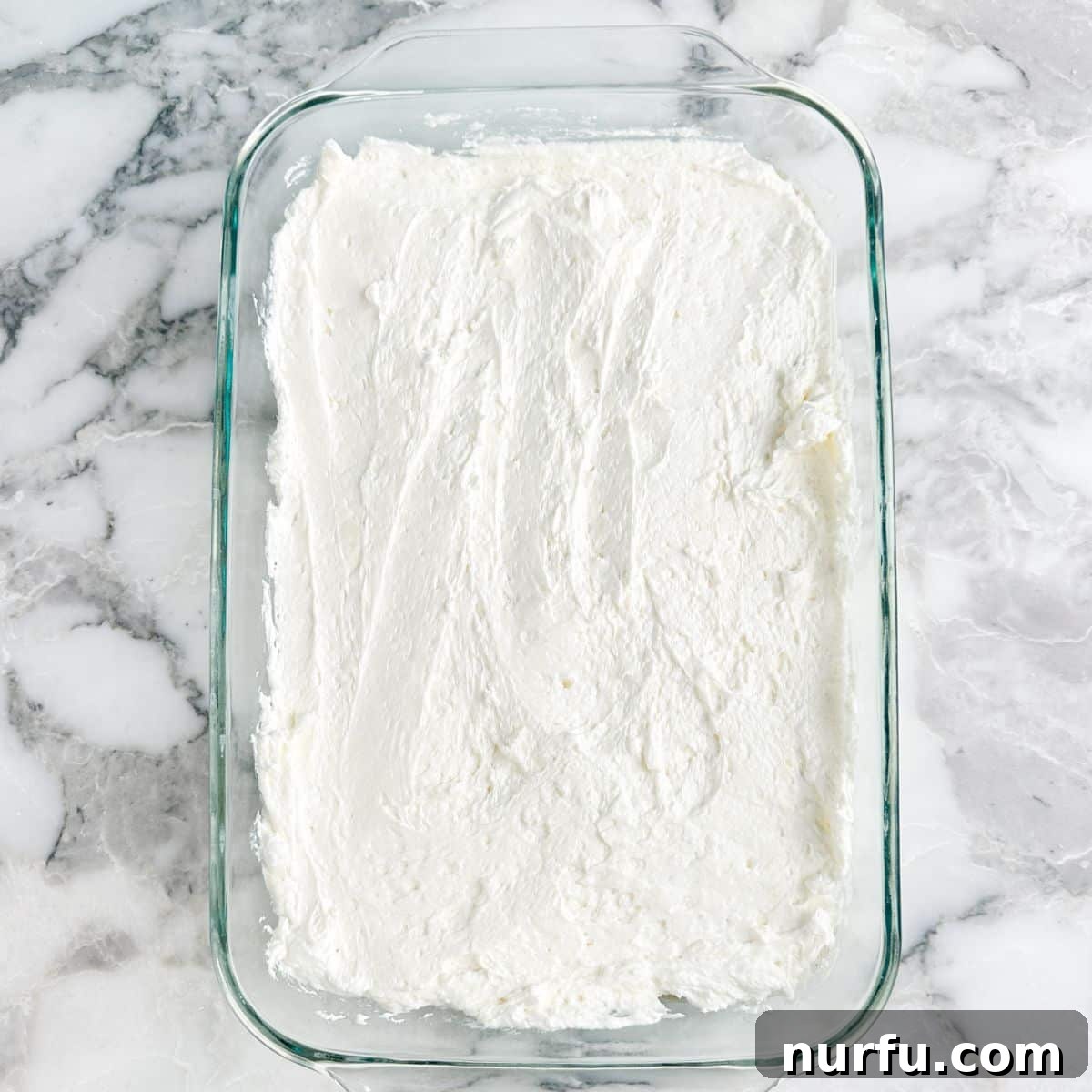 Butterscotch Dessert Recipes for Irresistible Treats 7 Baking dish with Cool Whip mixture spread in the dish.