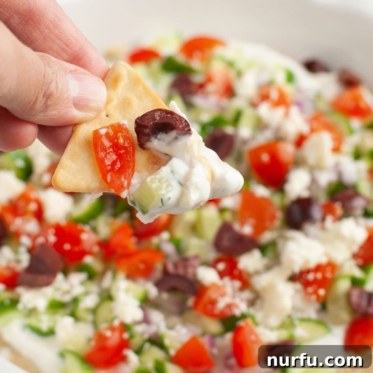 Mediterranean Greek Layer Dip Recipe – Flavorful Party Appetizer 7 Pita chip with Greek layer dip.