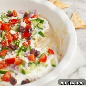 Mediterranean Greek Layer Dip Recipe – Flavorful Party Appetizer 8 Greek layer dip in a pie dish.
