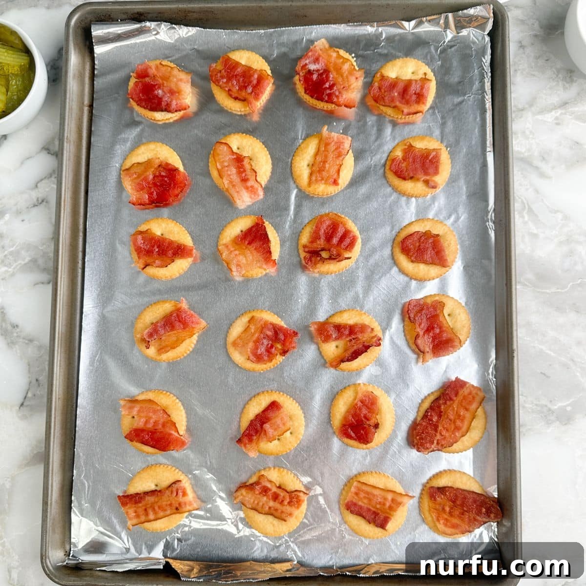 Ritz Crackers with Bacon and Pickle Spread: Crispy Party Snack 4 Baking pan with Ritz crackers topped with bacon.