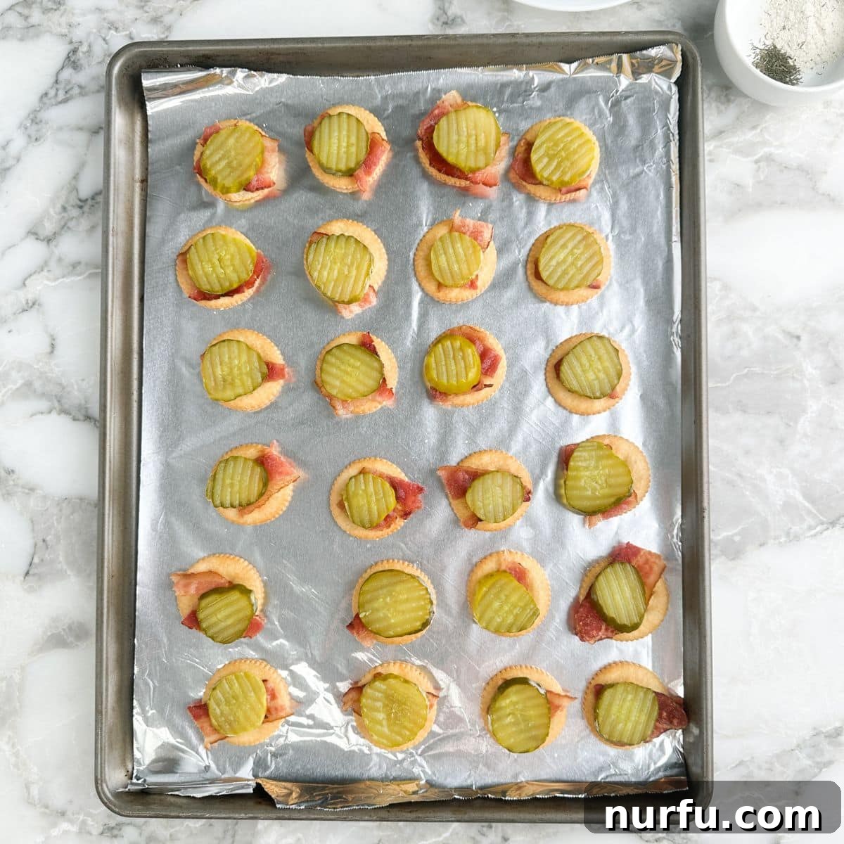 Ritz Crackers with Bacon and Pickle Spread: Crispy Party Snack 5 Crackers topped with bacon and dill pickle slices.