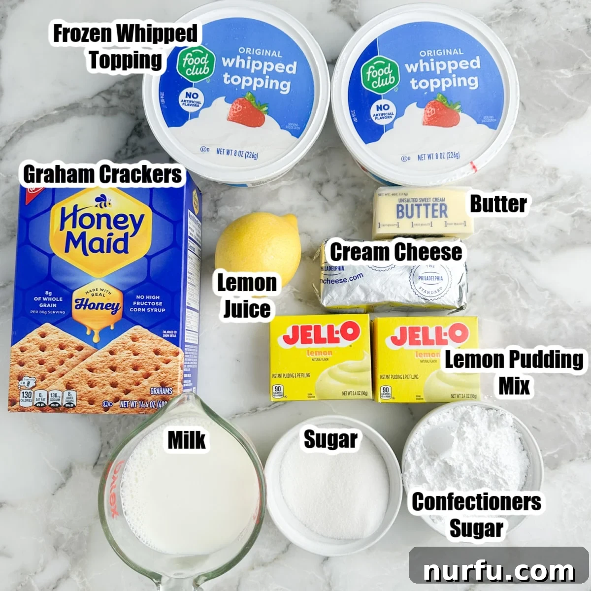 Frozen whipped topping, graham crackers, lemon, pudding mix, cream cheese, butter, milk, and sugar.