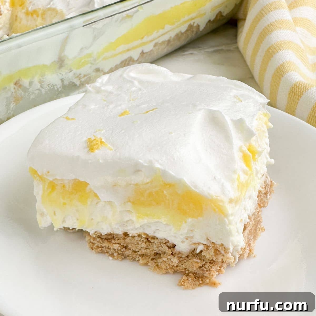 Piece of lemon lush on a plate.