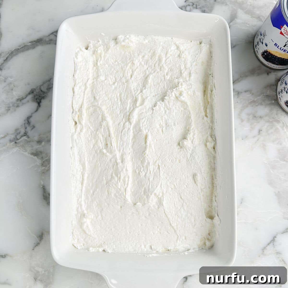 Growing Blueberries in Snowy Climates: Winter Care Tips 5 Baking dish with layer of cream cheese mixture.