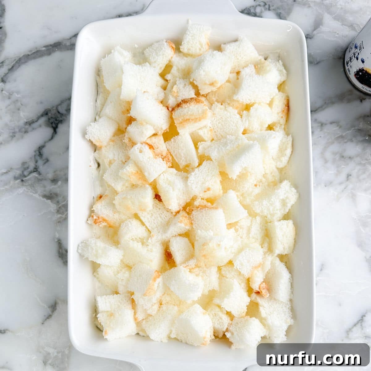 Growing Blueberries in Snowy Climates: Winter Care Tips 6 Baking dish with cubed angel food cake.