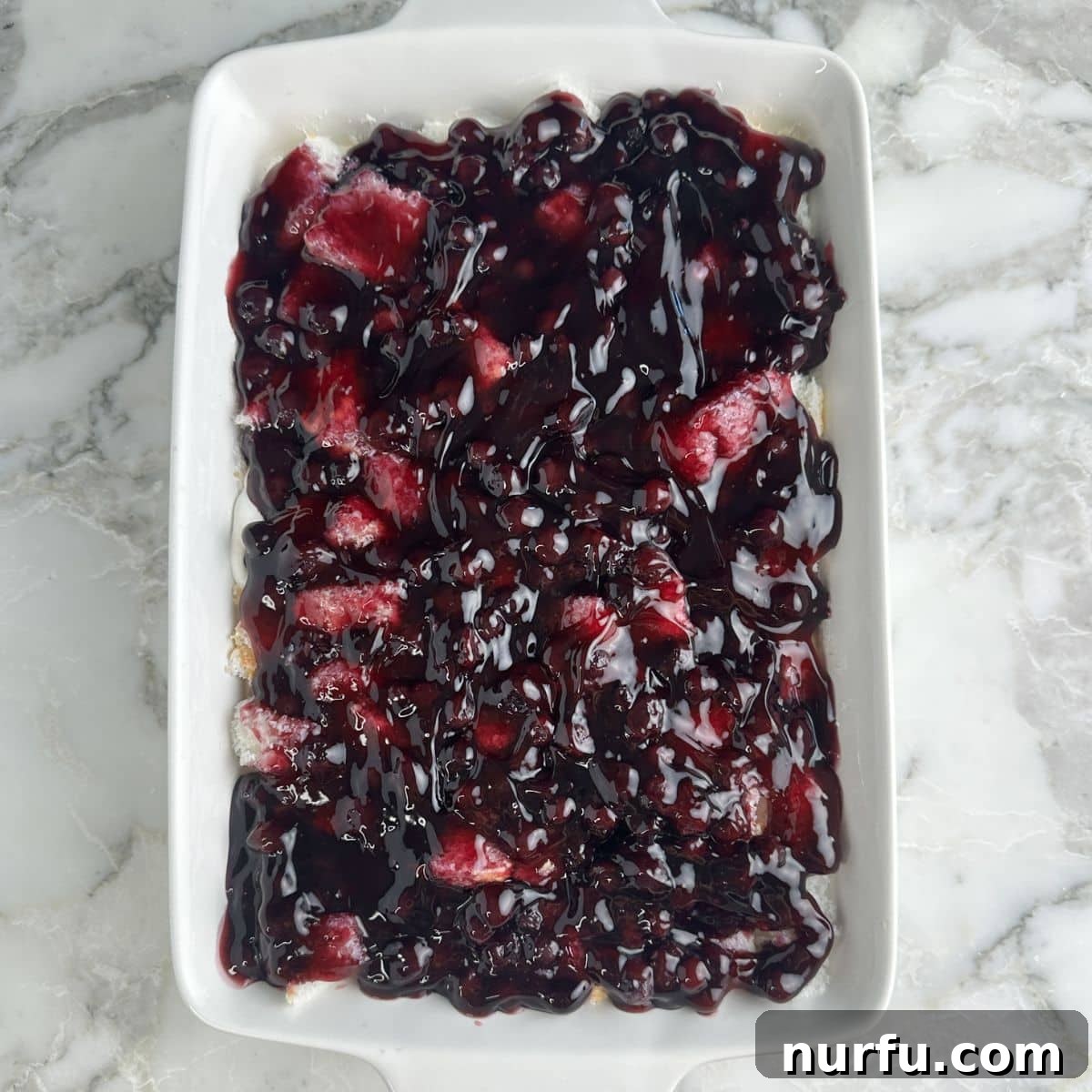 Growing Blueberries in Snowy Climates: Winter Care Tips 7 Baking dish with blueberry angel food cake dessert.