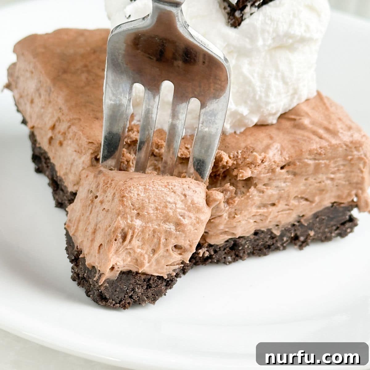 Plate with chocolate Cool Whip pie and a fork.